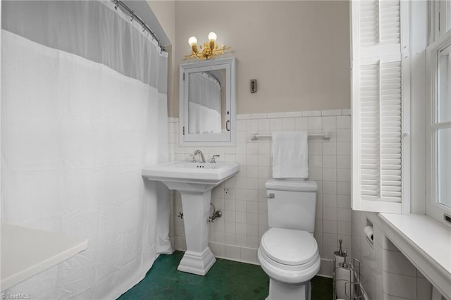 bathroom featuring toilet, decorative backsplash, and tile walls