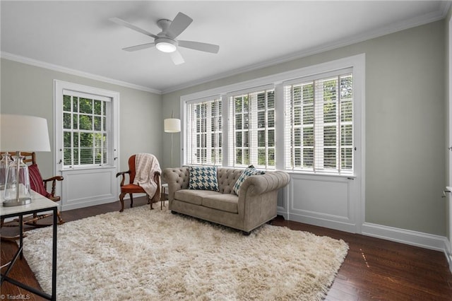 sitting room featuring dark hardwood / wood-style floors, crown molding, a wealth of natural light, and ceiling fan