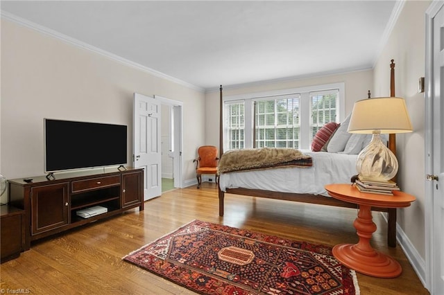 bedroom featuring ornamental molding and light hardwood / wood-style flooring