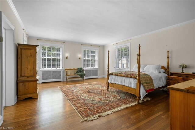 bedroom featuring hardwood / wood-style flooring and ornamental molding