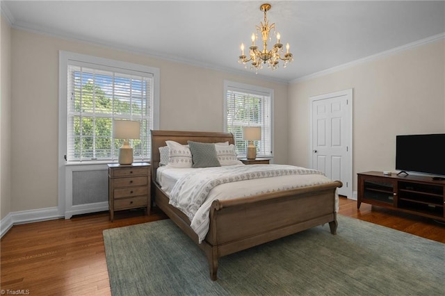 bedroom featuring crown molding, dark hardwood / wood-style floors, multiple windows, and an inviting chandelier