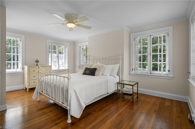 bedroom featuring ceiling fan, wood-type flooring, and ornamental molding