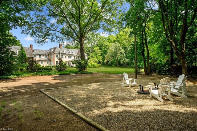 view of yard with an outdoor fire pit