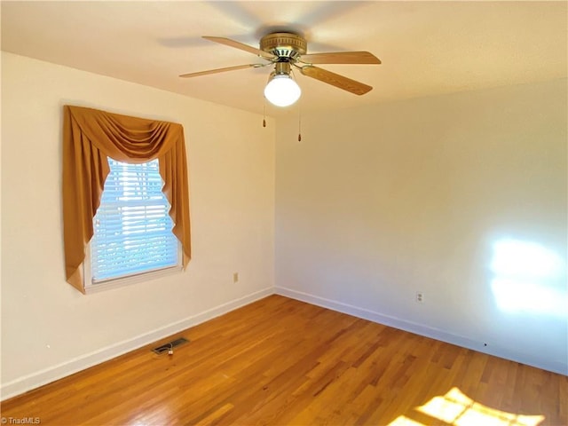 empty room featuring ceiling fan and wood-type flooring