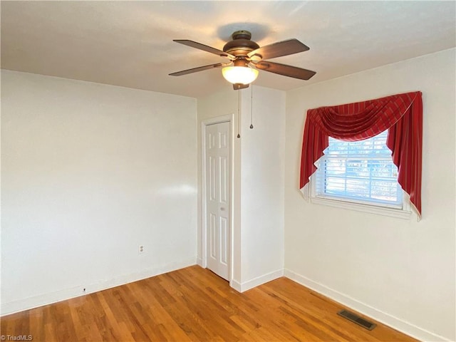 unfurnished room featuring ceiling fan and hardwood / wood-style flooring