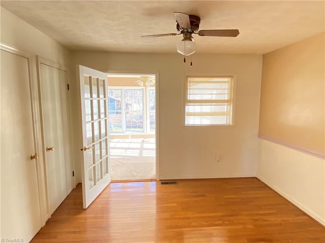 spare room featuring ceiling fan and hardwood / wood-style floors