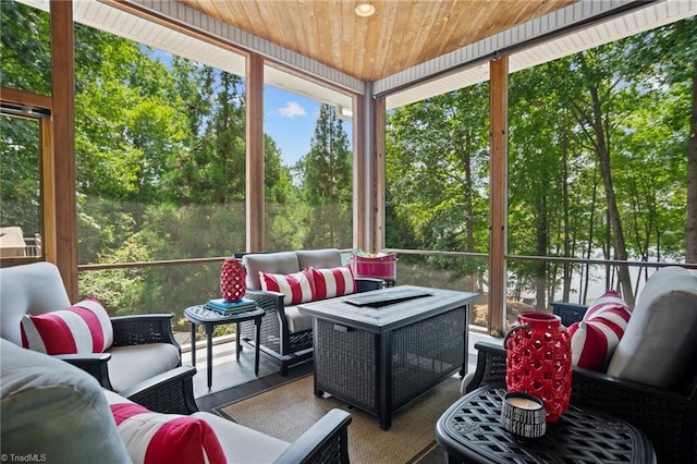 sunroom featuring plenty of natural light and wooden ceiling