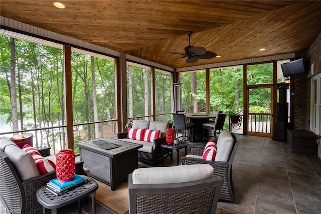 sunroom featuring ceiling fan, vaulted ceiling, and wood ceiling