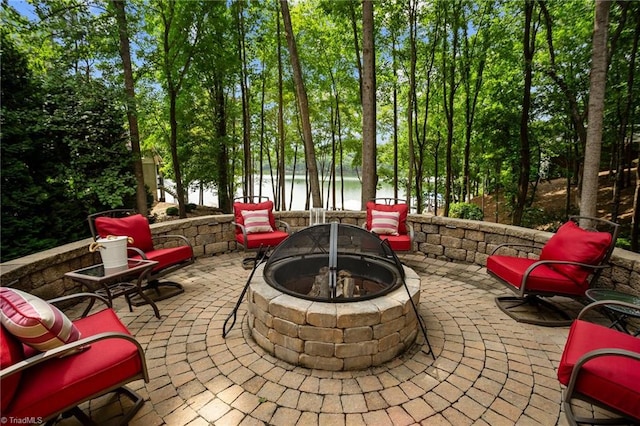 view of patio / terrace with a water view and an outdoor fire pit