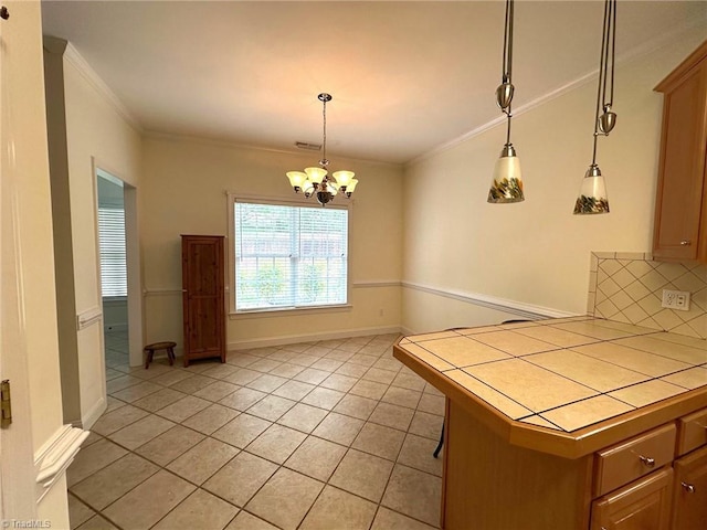 kitchen featuring crown molding, tile countertops, decorative backsplash, and light tile patterned floors
