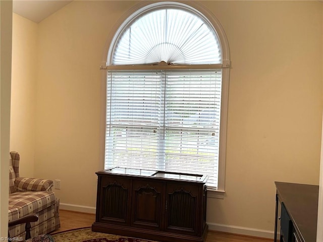 living area featuring baseboards and light wood-style flooring