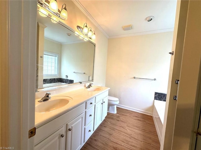bathroom with a sink, crown molding, double vanity, and wood finished floors