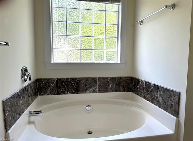 full bathroom featuring a healthy amount of sunlight and a garden tub