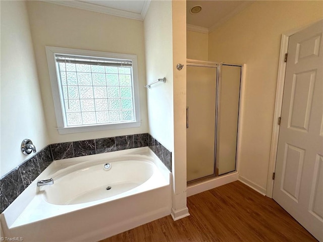 full bath featuring ornamental molding, wood finished floors, a bath, and a stall shower