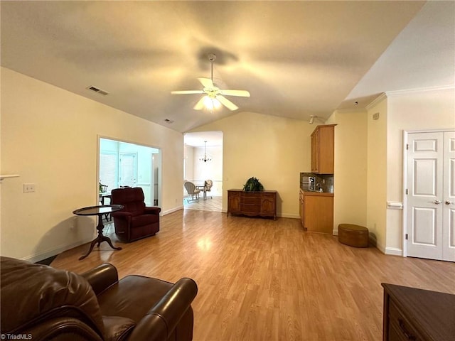 living room with a ceiling fan, visible vents, light wood-type flooring, baseboards, and lofted ceiling