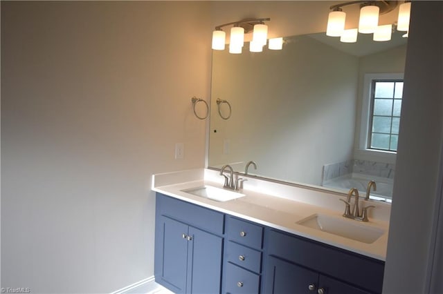 bathroom with vanity and a tub