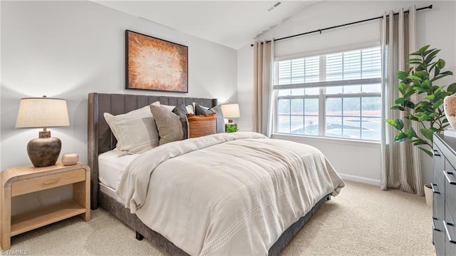 bedroom with lofted ceiling and light carpet