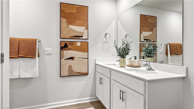 bathroom with hardwood / wood-style flooring and vanity