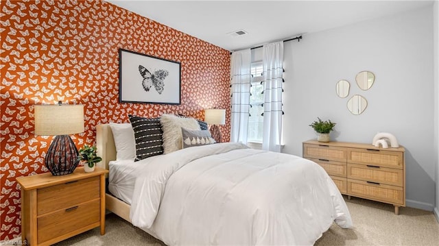 bedroom featuring light carpet