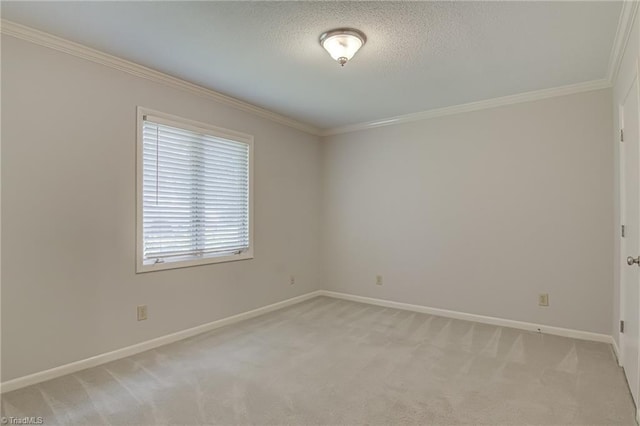empty room featuring crown molding, light carpet, baseboards, and a textured ceiling