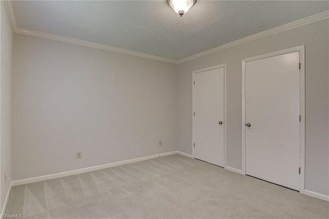 unfurnished bedroom featuring crown molding, light carpet, baseboards, and a textured ceiling