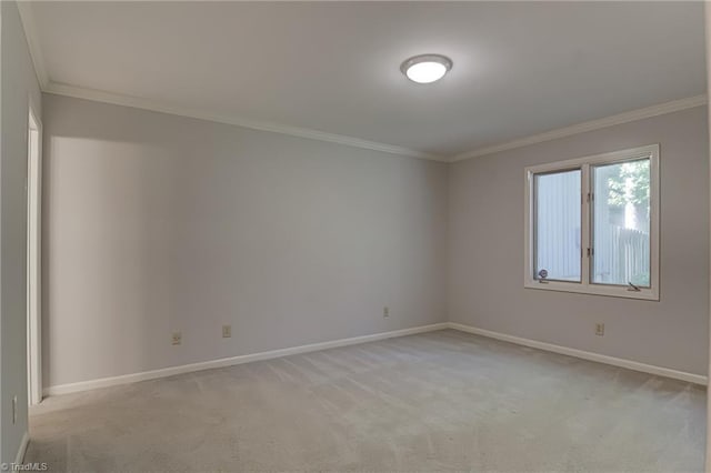 unfurnished room featuring crown molding, baseboards, and light carpet