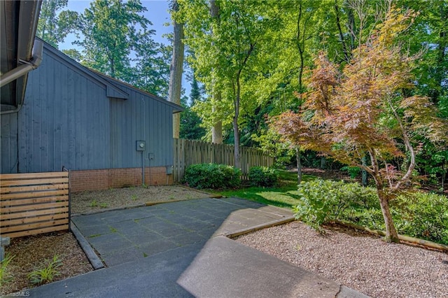 view of yard featuring fence and a patio area
