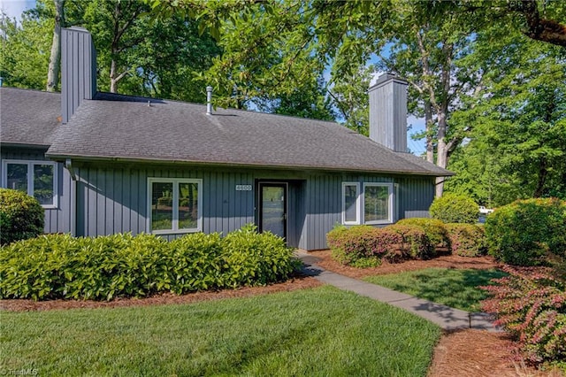 view of front of property with a chimney and a front yard