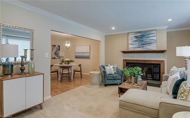 living room featuring recessed lighting, light colored carpet, crown molding, baseboards, and a glass covered fireplace