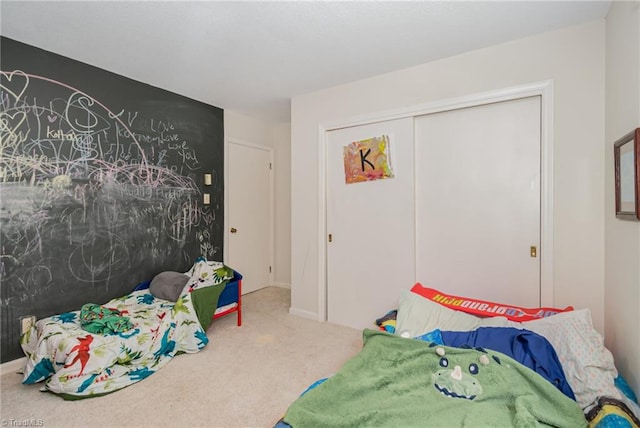 carpeted bedroom with a closet