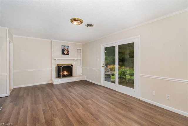 unfurnished living room with a fireplace, crown molding, and hardwood / wood-style floors