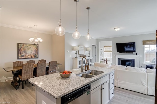 kitchen featuring a sink, light wood-style floors, open floor plan, ornamental molding, and dishwasher