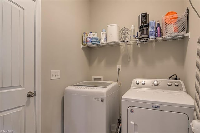 laundry area with laundry area and separate washer and dryer