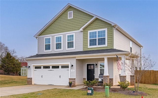 craftsman house with brick siding, concrete driveway, a front yard, fence, and a garage