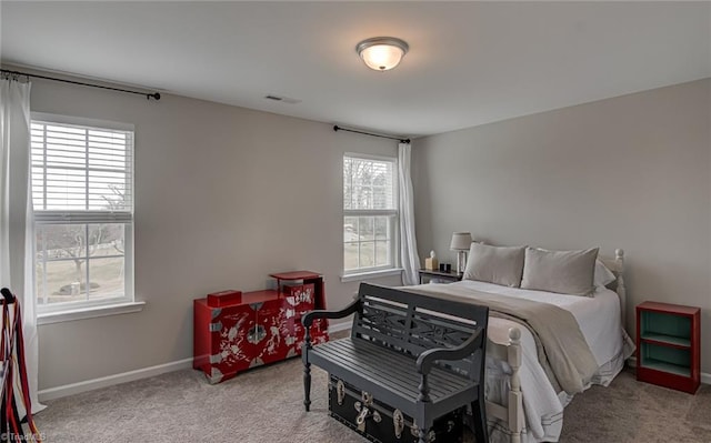 carpeted bedroom with visible vents and baseboards