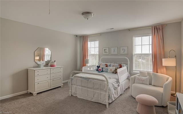 carpeted bedroom with visible vents and baseboards