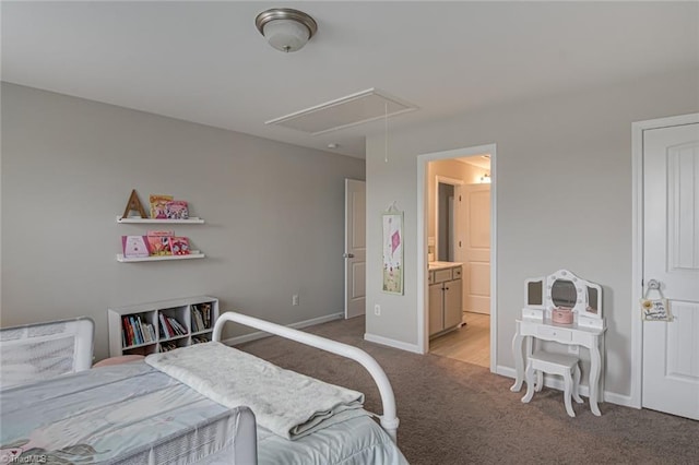 bedroom with attic access, light colored carpet, connected bathroom, and baseboards