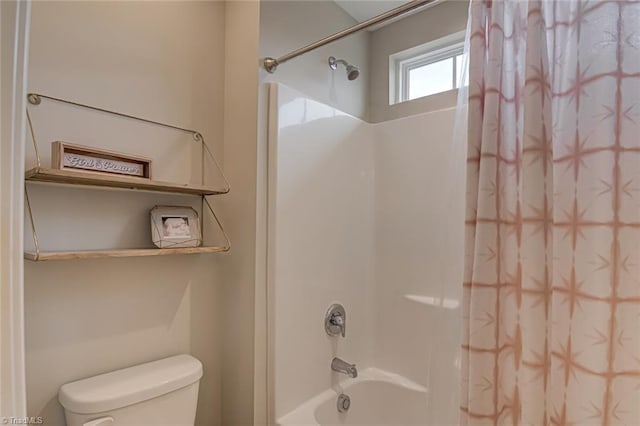 bathroom with shower / bath combo with shower curtain and toilet