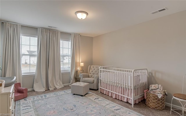 bedroom with carpet floors, visible vents, and baseboards