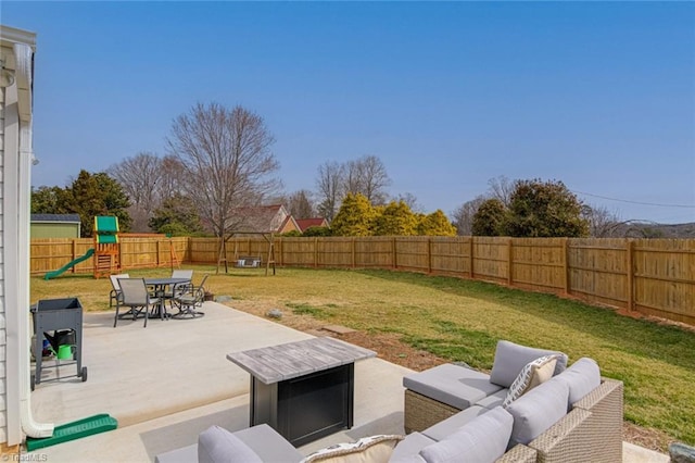 view of yard featuring an outdoor living space, a patio area, a playground, and a fenced backyard