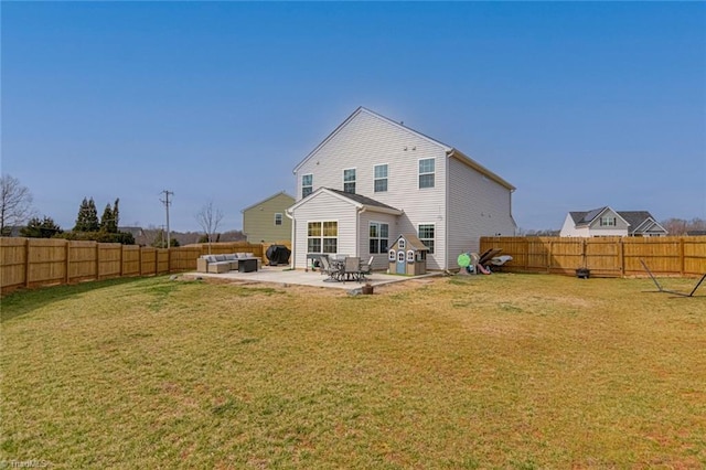 back of house with a fenced backyard, a yard, and a patio