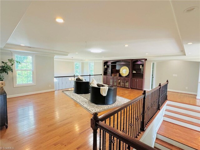 unfurnished bedroom with light carpet, a closet, ensuite bath, and ornamental molding