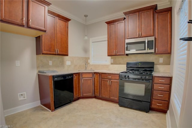 kitchen with light stone countertops, black appliances, hanging light fixtures, and sink