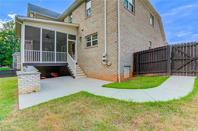 exterior space featuring a patio, a yard, and ceiling fan