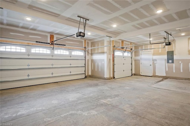 garage with electric panel and a garage door opener