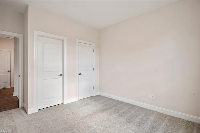 unfurnished bedroom with light carpet