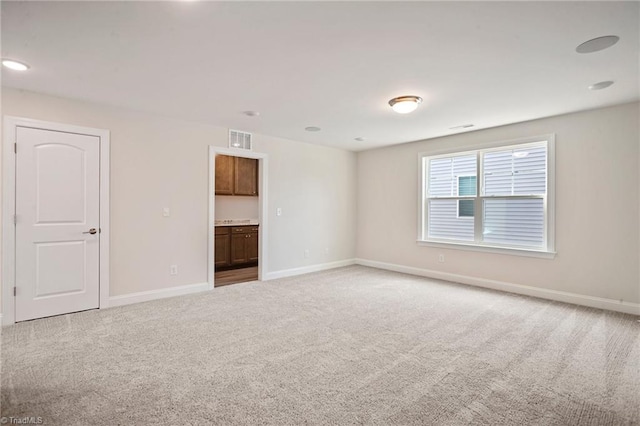 unfurnished room with light colored carpet