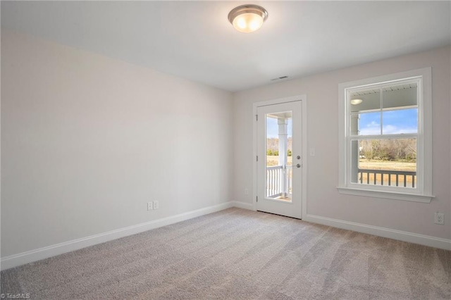 empty room with plenty of natural light and light colored carpet