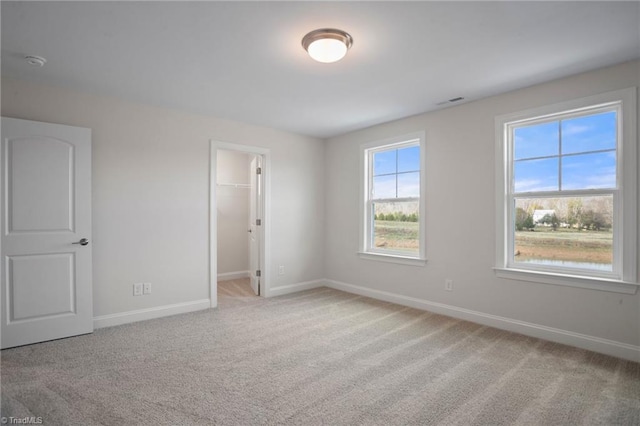 unfurnished room featuring light carpet