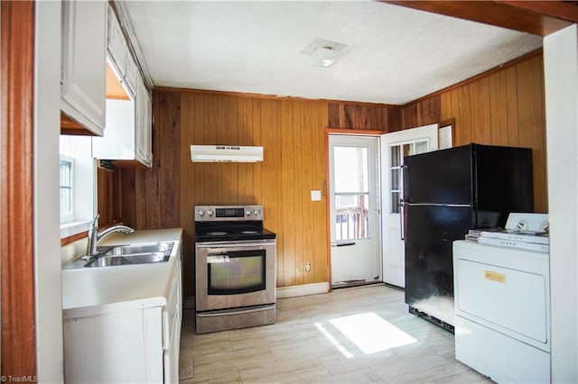 kitchen with washer / dryer, a healthy amount of sunlight, black fridge, and stainless steel electric range